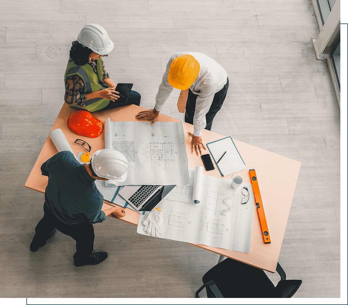 Architects discussing blueprints at table